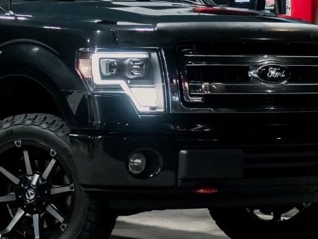 Raxiom Axial Series G4 Light Bar Switchback Projector Headlights; Black Housing; Clear Lens (09-14 F-150 w/ Factory Halogen Headlights)