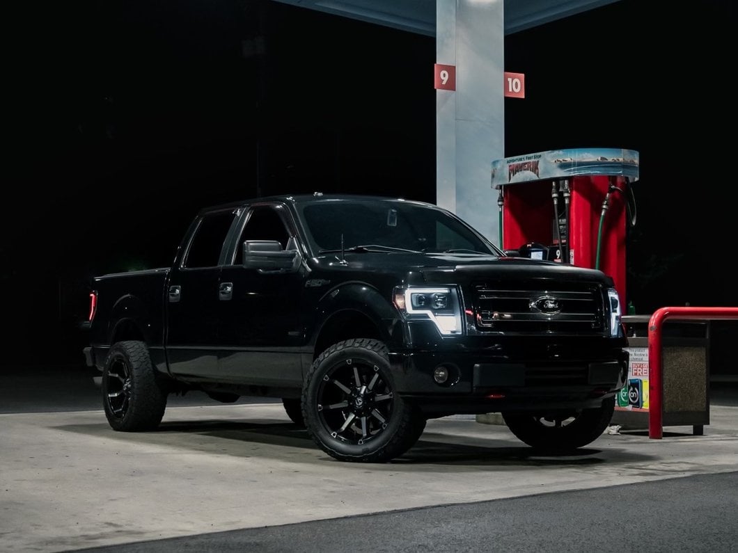 Raxiom Axial Series G4 Light Bar Switchback Projector Headlights; Black Housing; Clear Lens (09-14 F-150 w/ Factory Halogen Headlights)