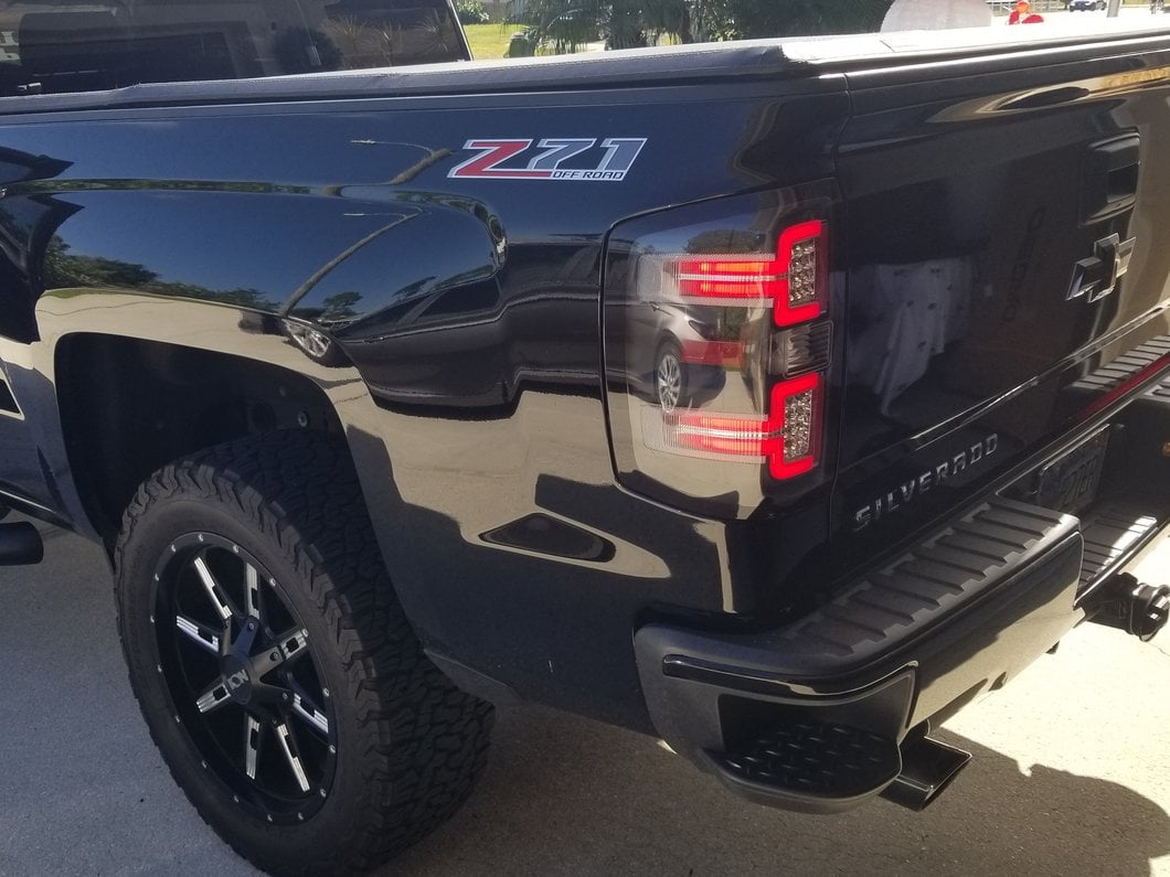 Raxiom LED Tail Lights with Sequential Turn Signals; Black Housing; Clear Lens (14-18 Silverado 1500 w/ Factory Halogen Tail Lights)