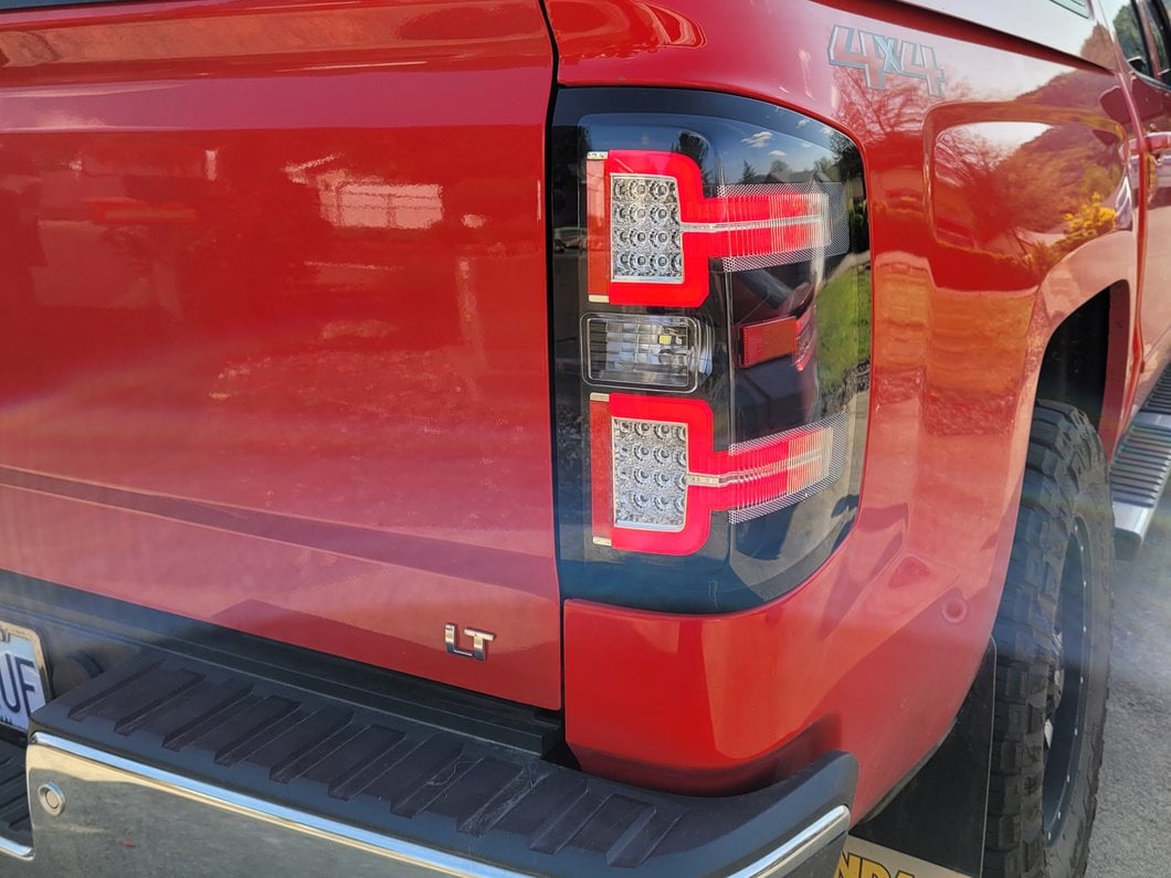 Raxiom LED Tail Lights with Sequential Turn Signals; Black Housing; Clear Lens (14-18 Silverado 1500 w/ Factory Halogen Tail Lights)