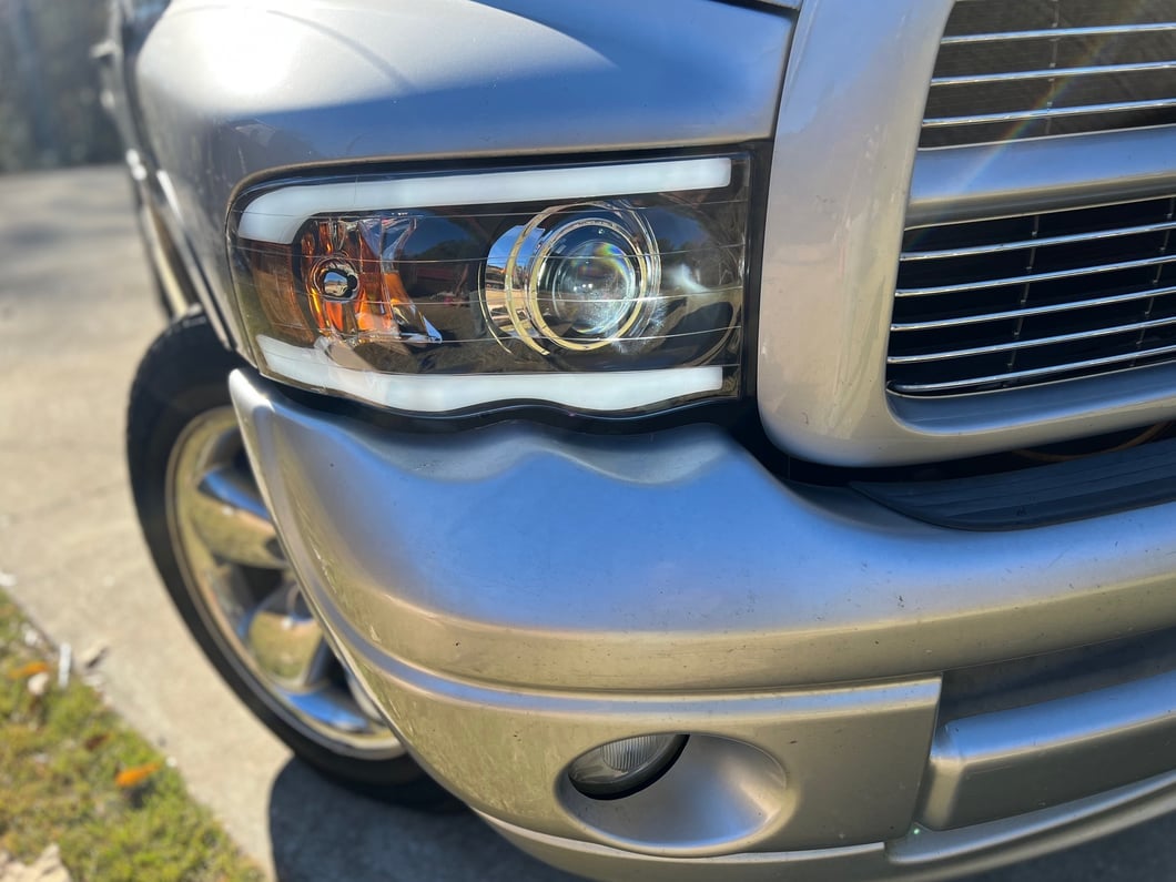 Raxiom Axial Series LED Projector Headlights with Sequential LED Bar; Black Housing; Clear Lens (02-05 RAM 1500)