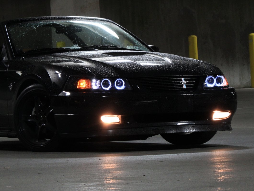 Raxiom Dual LED Halo Projector Headlights; Black Housing; Smoked Lens (99-04 Mustang)