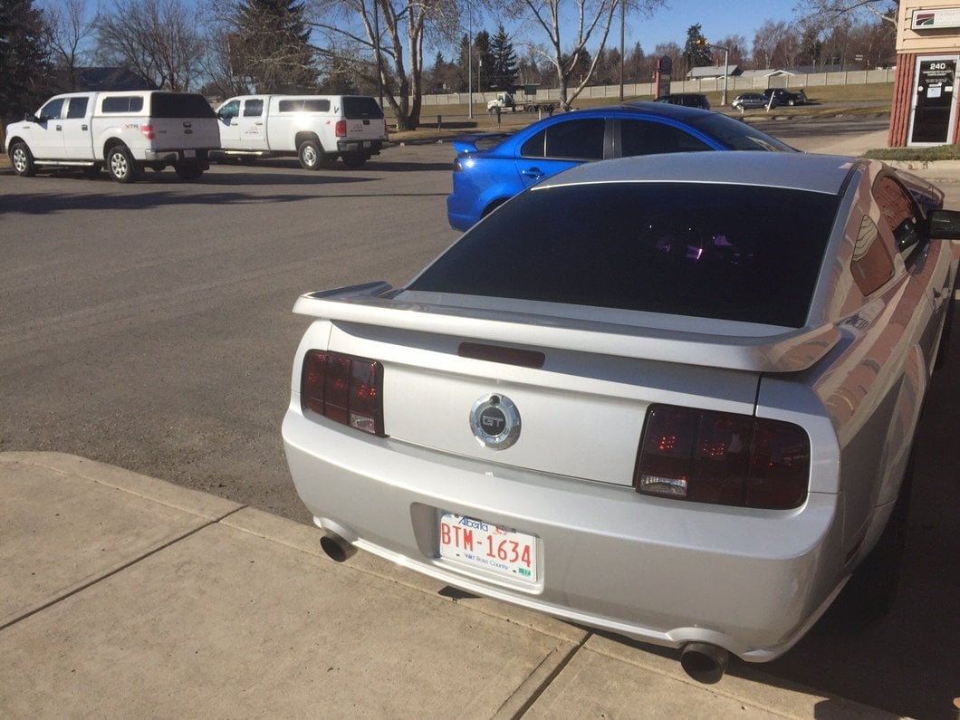 Raxiom Tail Lights and Sequential Tail Light Kit; Black Housing; Smoked Lens (05-09 Mustang)