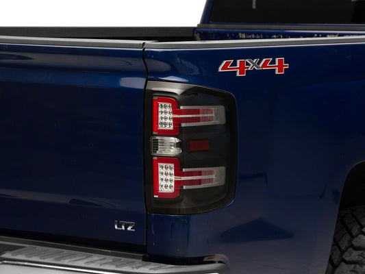 Raxiom LED Tail Lights with Sequential Turn Signals; Black Housing; Clear Lens (14-18 Silverado 1500 w/ Factory Halogen Tail Lights)