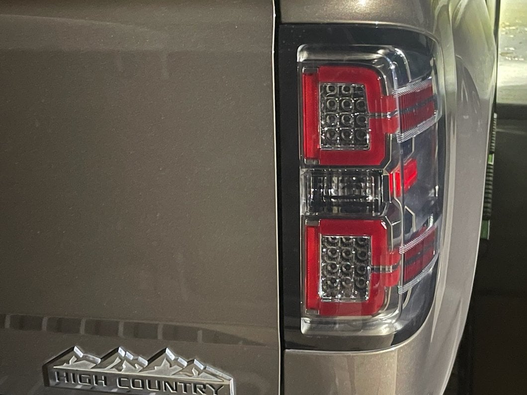 Raxiom LED Tail Lights with Sequential Turn Signals; Chrome Housing; Smoked Lens (14-18 Silverado 1500 w/ Factory Halogen Tail Lights)