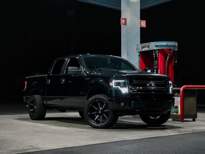 Raxiom Axial Series G4 Light Bar Switchback Projector Headlights; Black Housing; Clear Lens (09-14 F-150 w/ Factory Halogen Headlights)