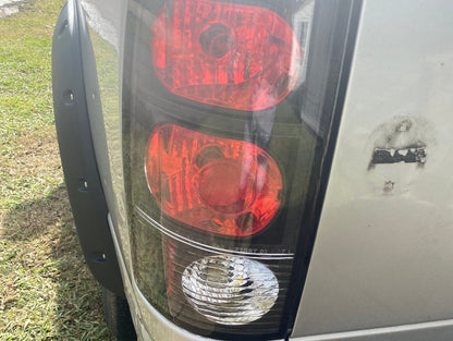Raxiom Axial Series Tail Lights; Black Housing; Red/Clear Lens (02-05 RAM 1500)