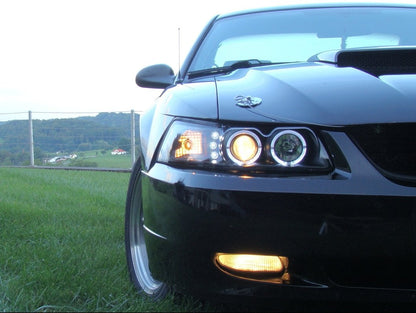 Raxiom Dual LED Halo Projector Headlights; Black Housing; Clear Lens (99-04 Mustang)