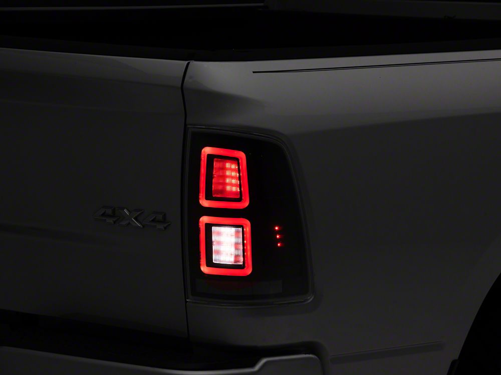 Raxiom LED Tail Lights; Black Housing; Clear Lens (09-18 RAM 1500 w/ Factory Halogen Tail Lights)