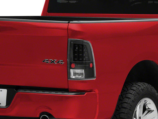 Raxiom LED Tail Lights; Black Housing; Clear Lens (09-18 RAM 1500 w/ Factory Halogen Tail Lights)